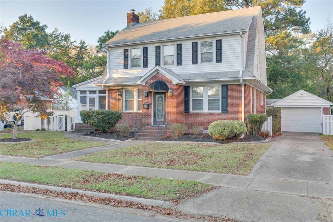 144 Meredith Street Hampton, VA 23669 - Photo 3 of 36 a front view of a house with a garden and trees