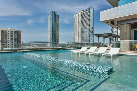 a view of swimming pool with outdoor seating and city view