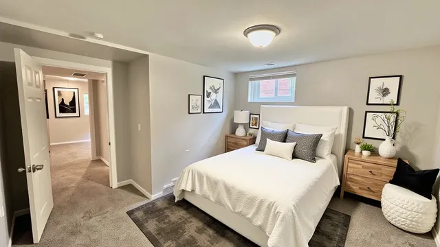 a bedroom with a bed and a painting on the wall