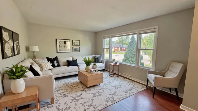 a living room with furniture and a large window