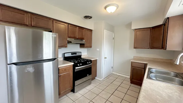a kitchen with stainless steel appliances a refrigerator stove and sink