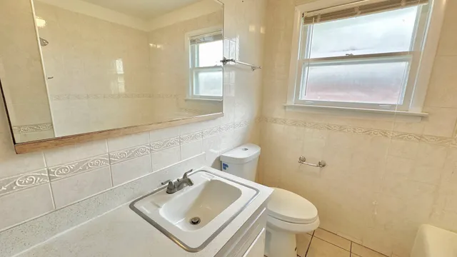 a bathroom with a sink toilet and mirror