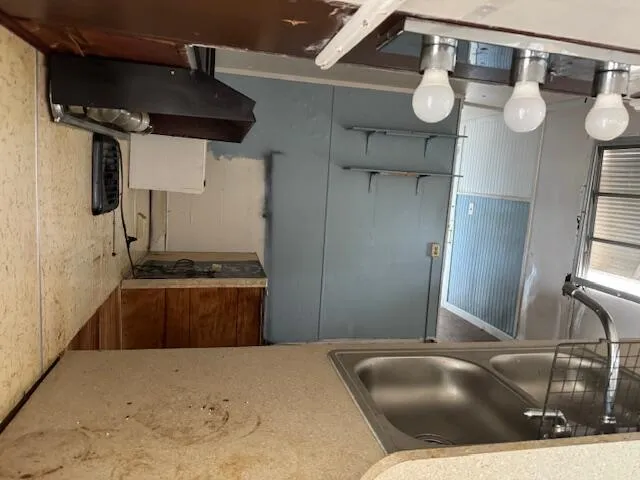 a kitchen with stainless steel appliances kitchen island granite countertop a sink refrigerator stove and microwave