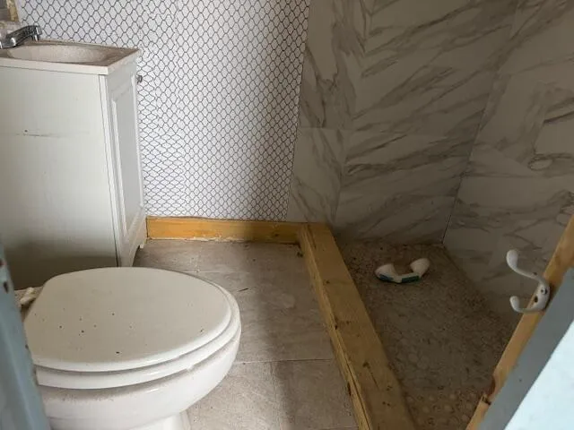 a bathroom with a toilet and a sink