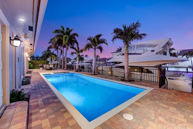 a view of a swimming pool with a table and chairs