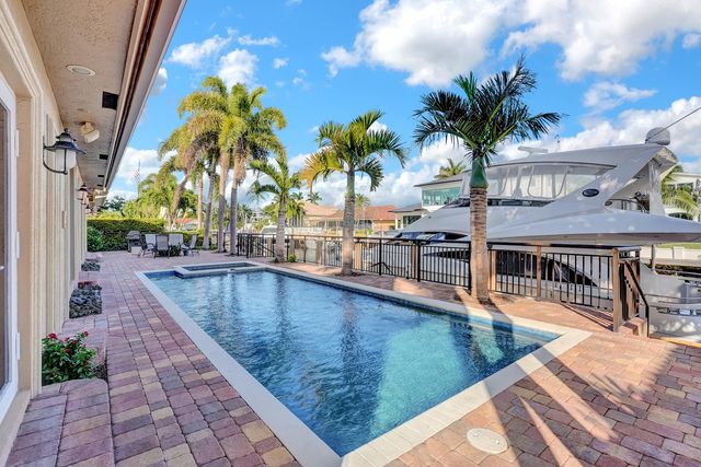 a spacious bathroom with a granite countertop double vanity sink a mirror a toilet and a shower