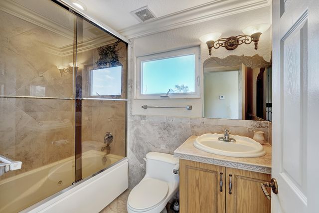 a living room with fireplace furniture and a floor to ceiling window