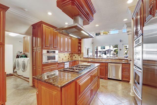 a view of a house with a small yard and flower plants
