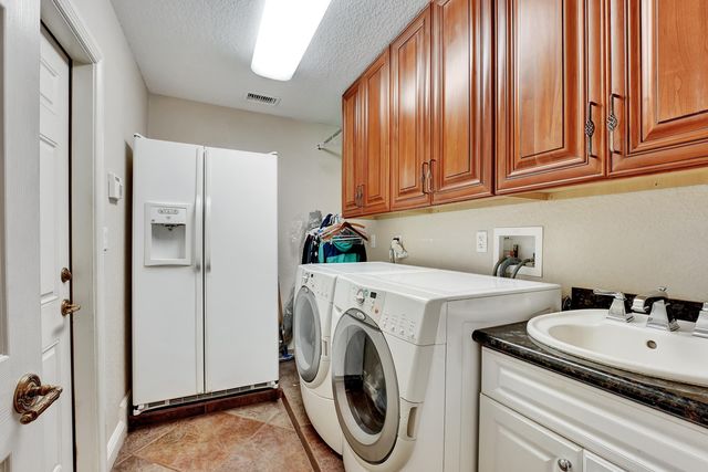 a front view of a house with plants