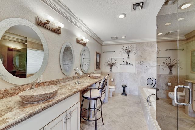 an aerial view of a house with swimming pool and outdoor seating