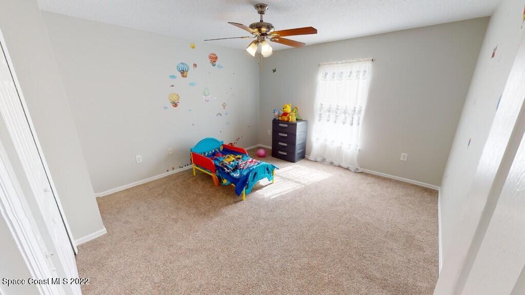 2343 Angel Road Palm Bay, FL 32909 - Photo 20 of 28 an empty room with windows and fan