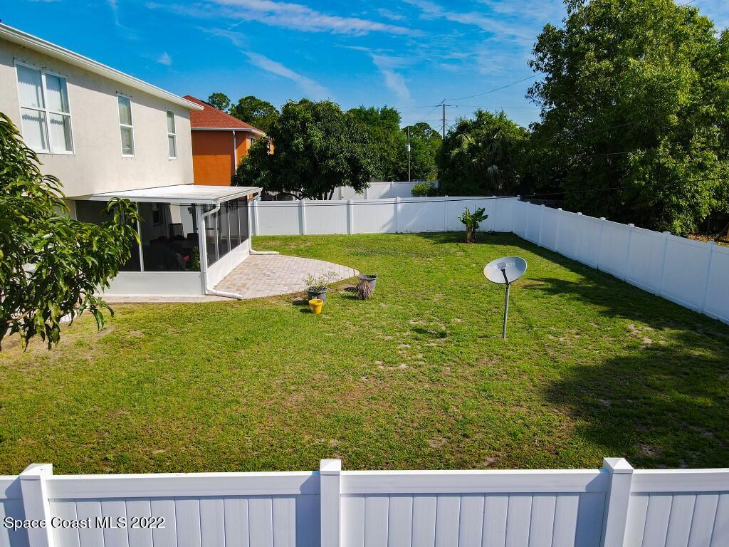 2343 Angel Road Palm Bay, FL 32909 - Photo 25 of 28 a view of a swimming pool with a patio and a yard