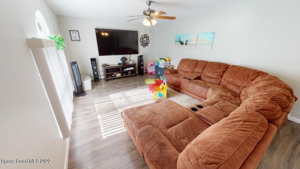 2343 Angel Road Palm Bay, FL 32909 - Photo 3 of 28 a living room with furniture and a flat screen tv