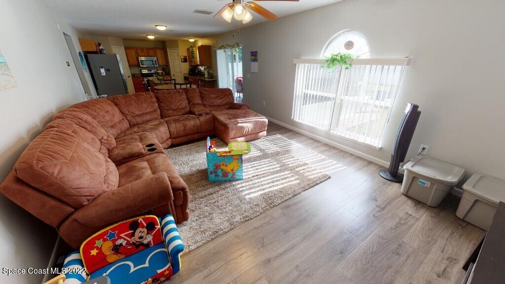 2343 Angel Road Palm Bay, FL 32909 - Photo 5 of 28 a living room with furniture and a wooden floor