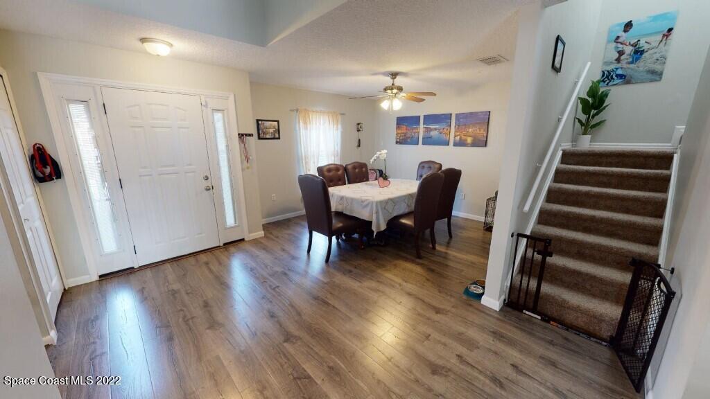 2343 Angel Road Palm Bay, FL 32909 - Photo 7 of 28 a view of a dining room with furniture and wooden floor