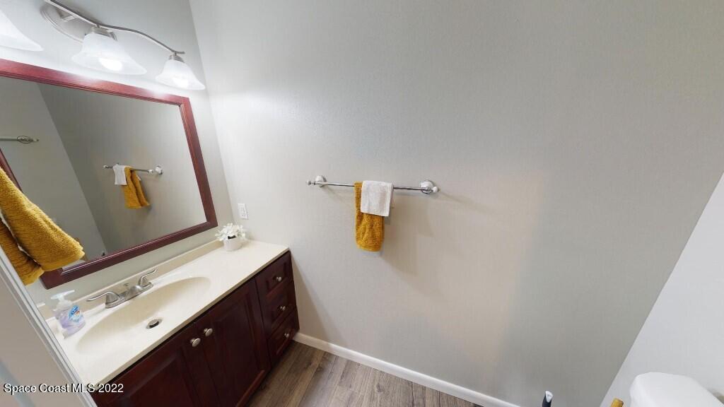 2343 Angel Road Palm Bay, FL 32909 - Photo 8 of 28 a bathroom with a sink and mirror with toilet