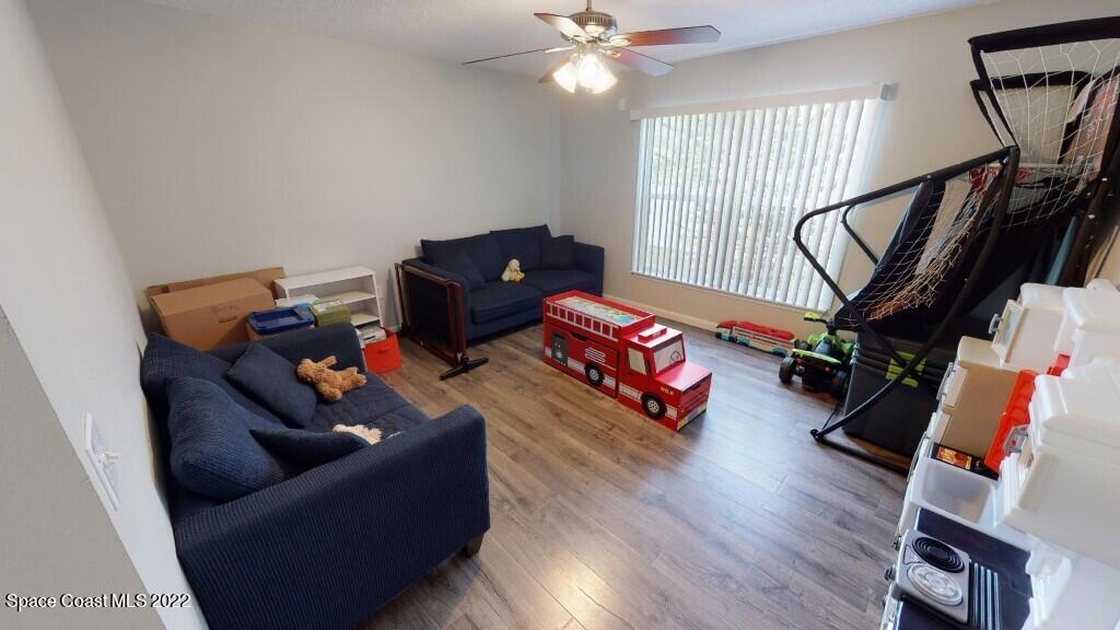 2343 Angel Road Palm Bay, FL 32909 - Photo 9 of 28 a living room with furniture and a wooden floor