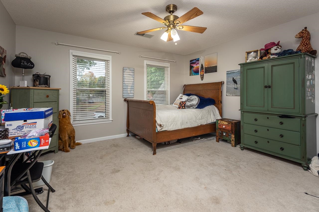 982 Handforth Cove Collierville, TN 38017 - Photo 15 of 25 a bedroom with a bed and furniture