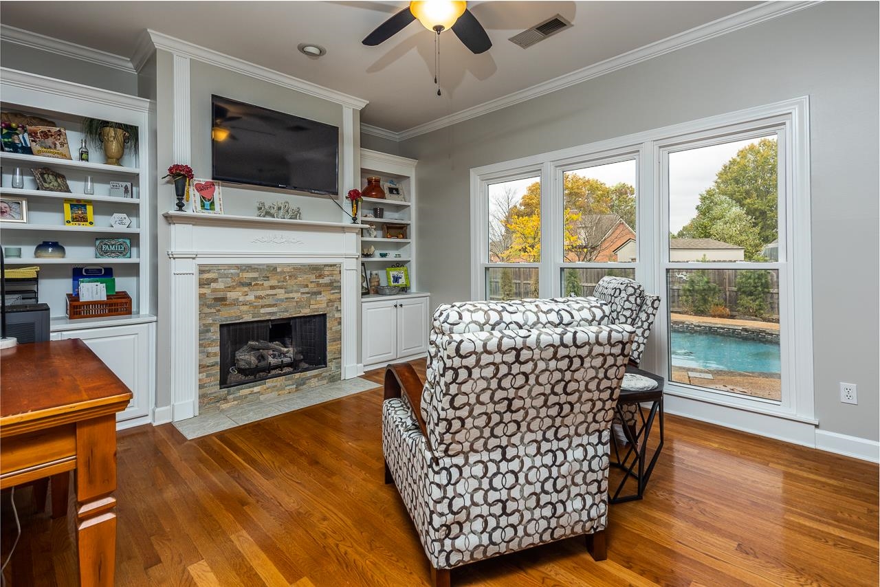 982 Handforth Cove Collierville, TN 38017 - Photo 8 of 25 a living room with furniture a flat screen tv and a fireplace