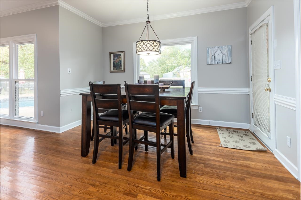 982 Handforth Cove Collierville, TN 38017 - Photo 10 of 25 a view of a dining room with furniture window and wooden floor