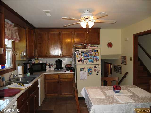 13153 Depot Road Hanover, VA 23069 - Photo 5 of 24 a kitchen with a sink dishwasher stove and refrigerator with wooden floor