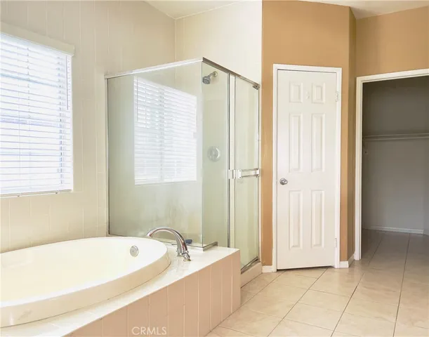 a bathroom with a tub a sink and a shower