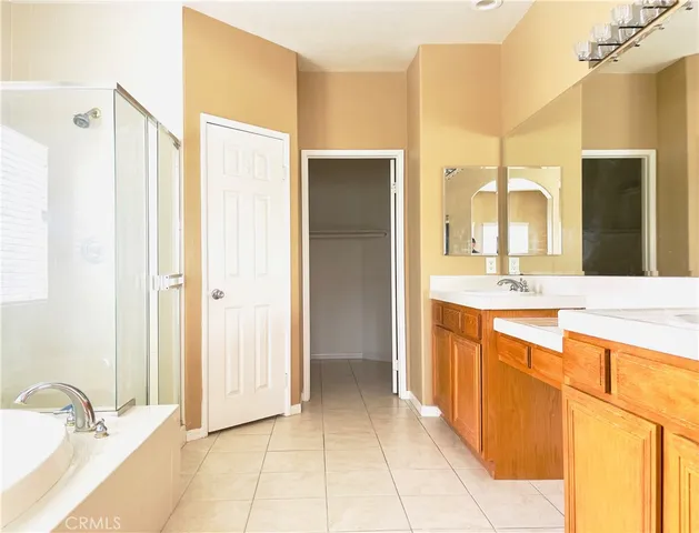 a bathroom with a double vanity sink mirror and shower