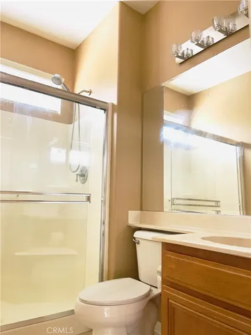 a bathroom with a toilet a sink and a shower