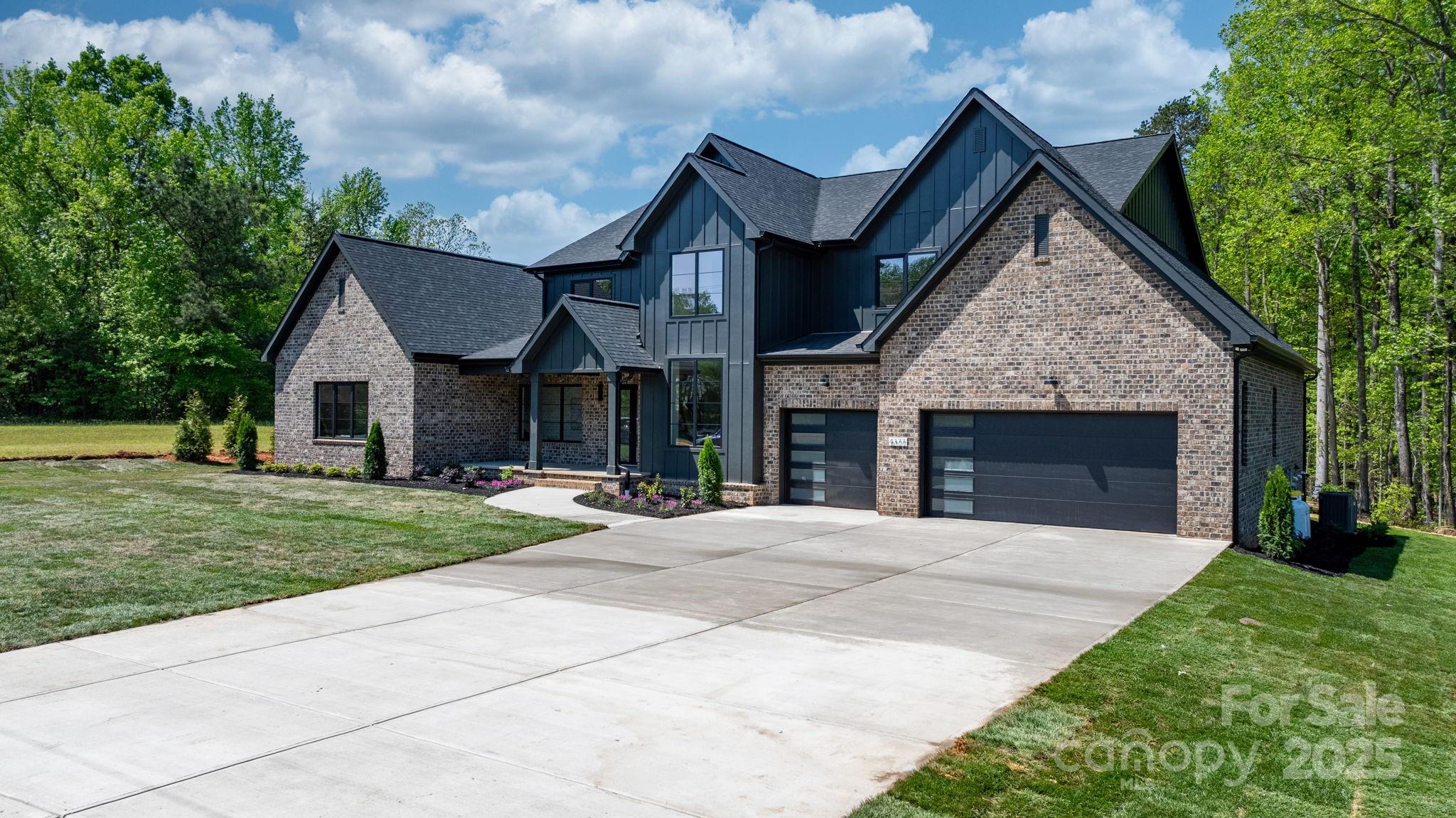4377 Kiser Island Road Terrell, NC 28682 - Photo 4 of 47 a front view of a house with a garden and trees