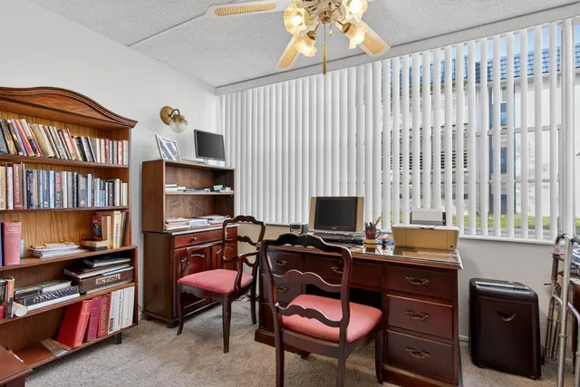 a living room with furniture and a piano