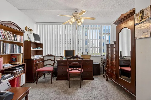 a bedroom with a bed dresser and a window