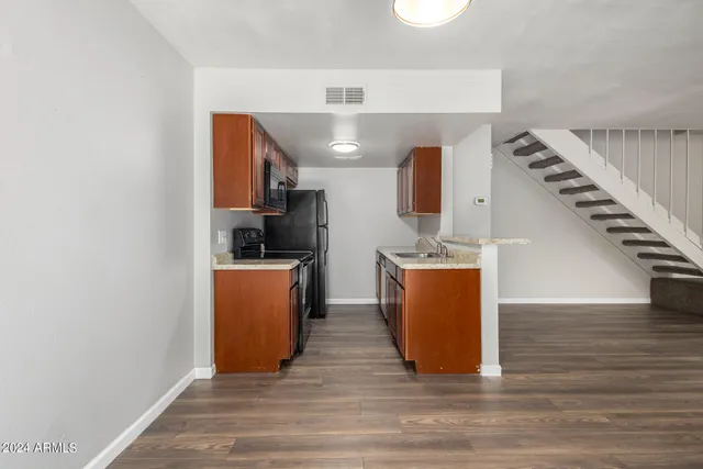 a view of kitchen and hall with wooden floor