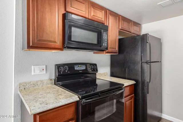 a kitchen with granite countertop cabinets and steel stainless steel appliances