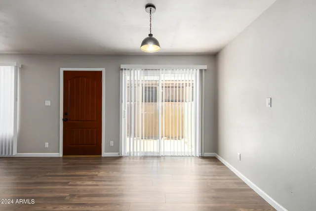 a view of a room with wooden floor and windows