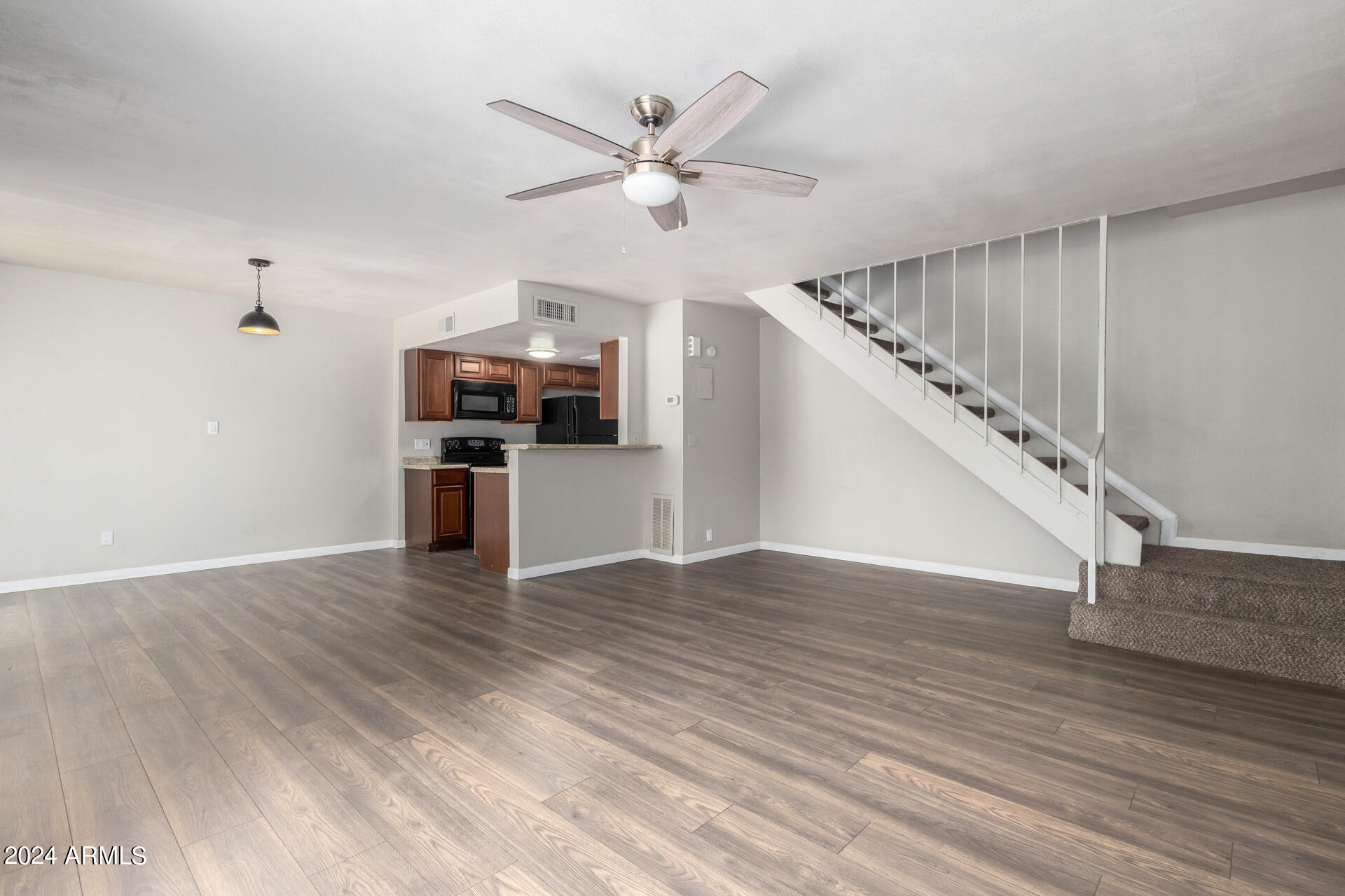17034 East Calle Del Oro, Unit C Fountain Hills, AZ 85268 - Photo 8 of 22 a view of a livingroom with wooden floor and a ceiling fan