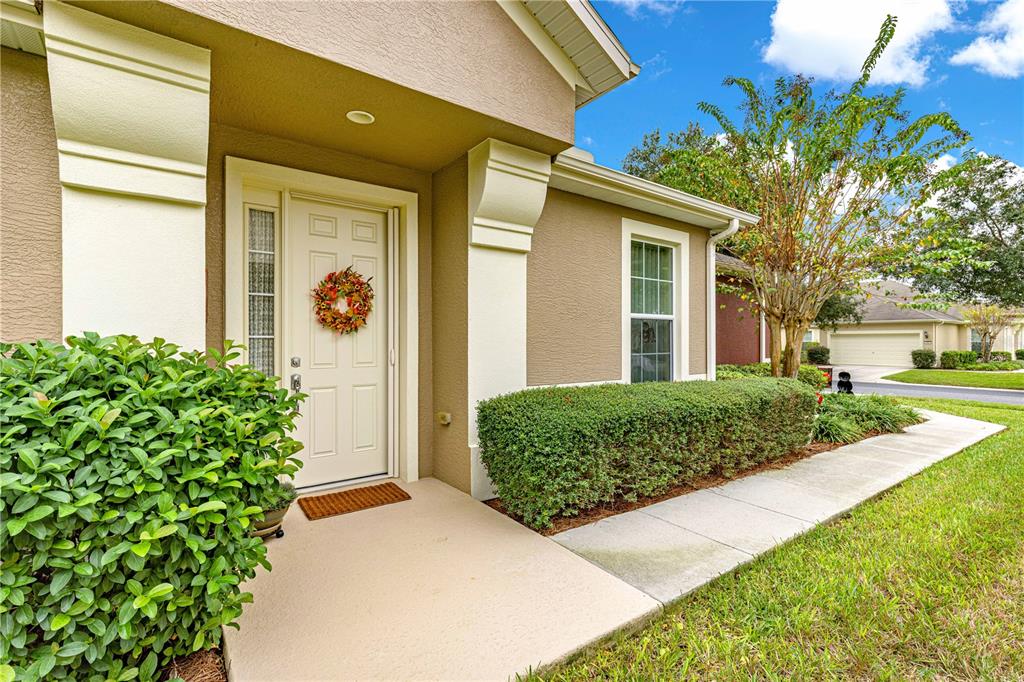 9566 Southwest 70th Loop Ocala, FL 34481 - Photo 1 of 53 a front view of a house with garden