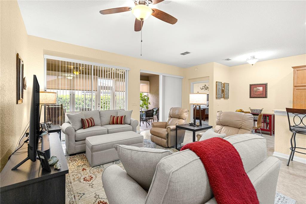 9566 Southwest 70th Loop Ocala, FL 34481 - Photo 15 of 53 a living room with furniture and a large window