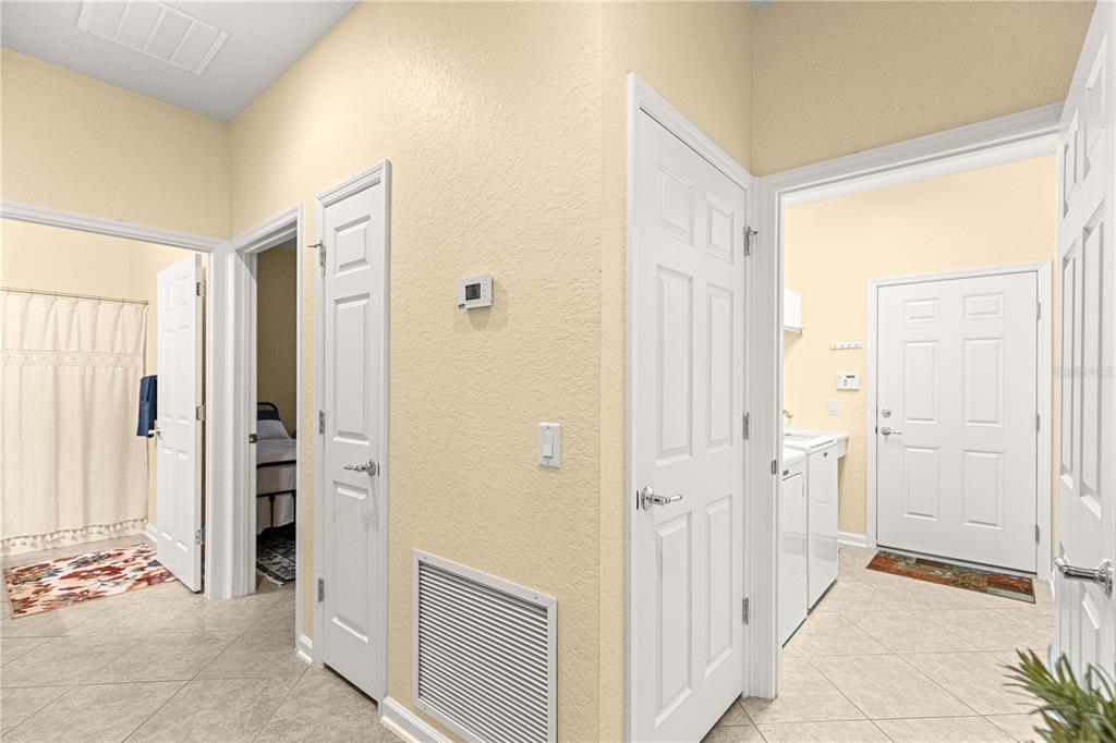 9566 Southwest 70th Loop Ocala, FL 34481 - Photo 18 of 53 a view of a bathroom with a walk in closet with wooden floor