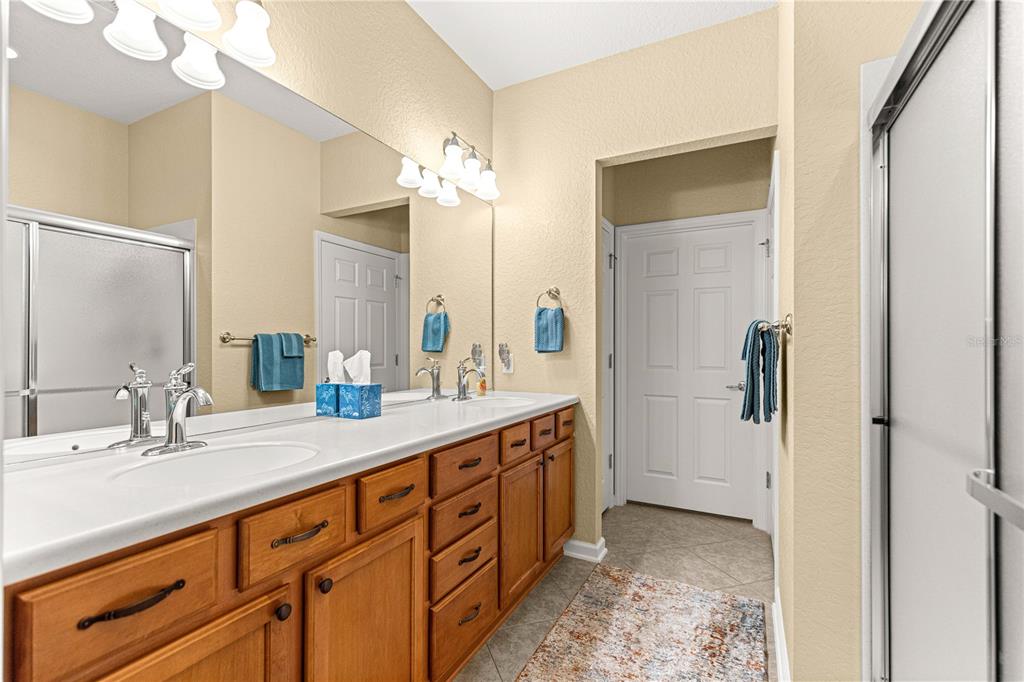 9566 Southwest 70th Loop Ocala, FL 34481 - Photo 23 of 53 a spacious bathroom with a double vanity sink and a mirror