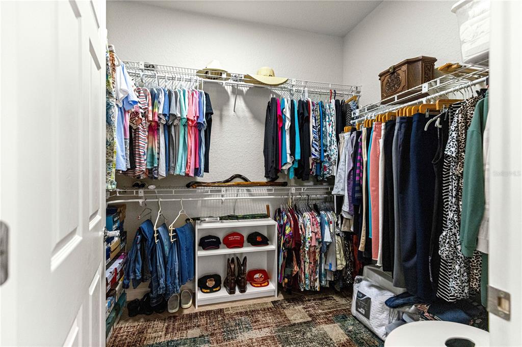 9566 Southwest 70th Loop Ocala, FL 34481 - Photo 25 of 53 a view of walk in closet with clothes