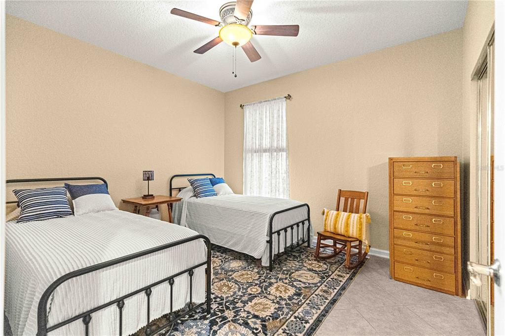 9566 Southwest 70th Loop Ocala, FL 34481 - Photo 26 of 53 a bedroom with two beds and painted walls