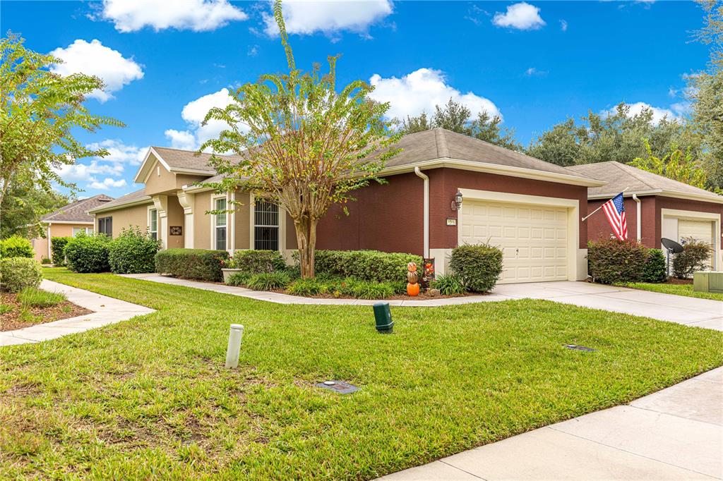 9566 Southwest 70th Loop Ocala, FL 34481 - Photo 37 of 53 a front view of a house with garden