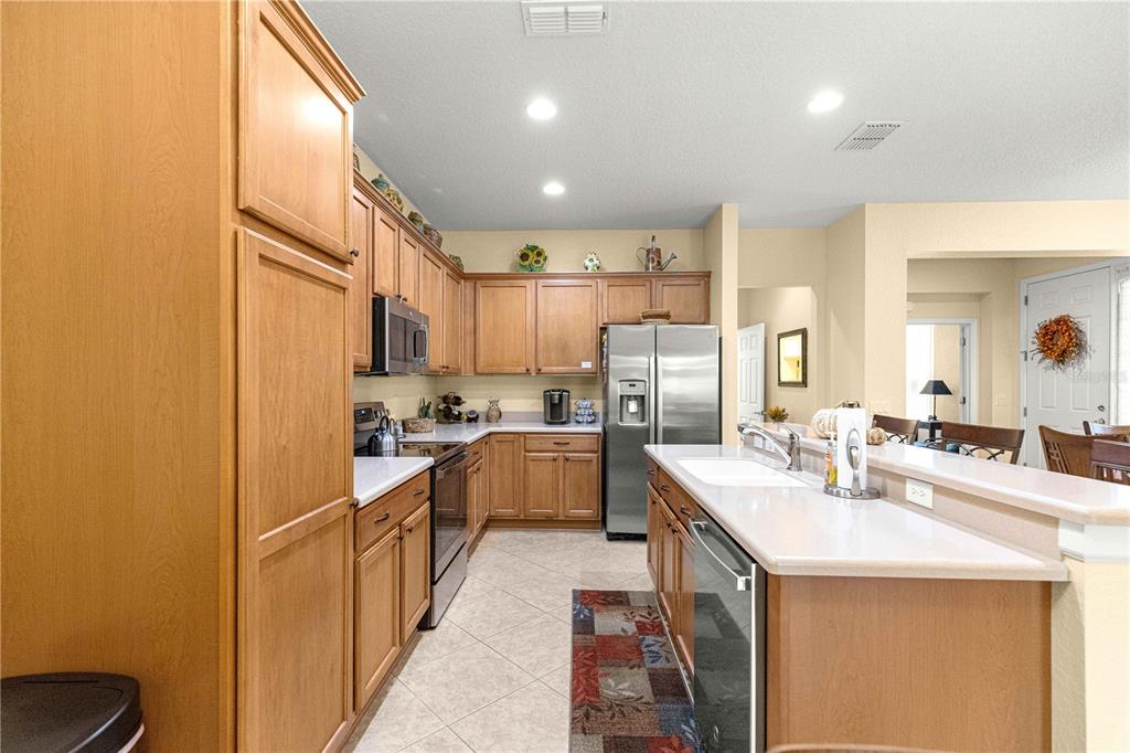 9566 Southwest 70th Loop Ocala, FL 34481 - Photo 9 of 53 a kitchen with stainless steel appliances granite countertop a sink and cabinets