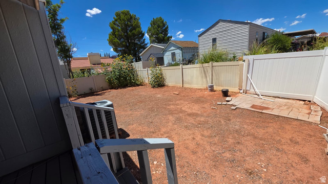 1450 North Dixie Downs Road, Unit 51 St. George, UT 84770 - Photo 15 of 25 Spacious backyard featuring an exposed earth surface and a partial concrete paver patio