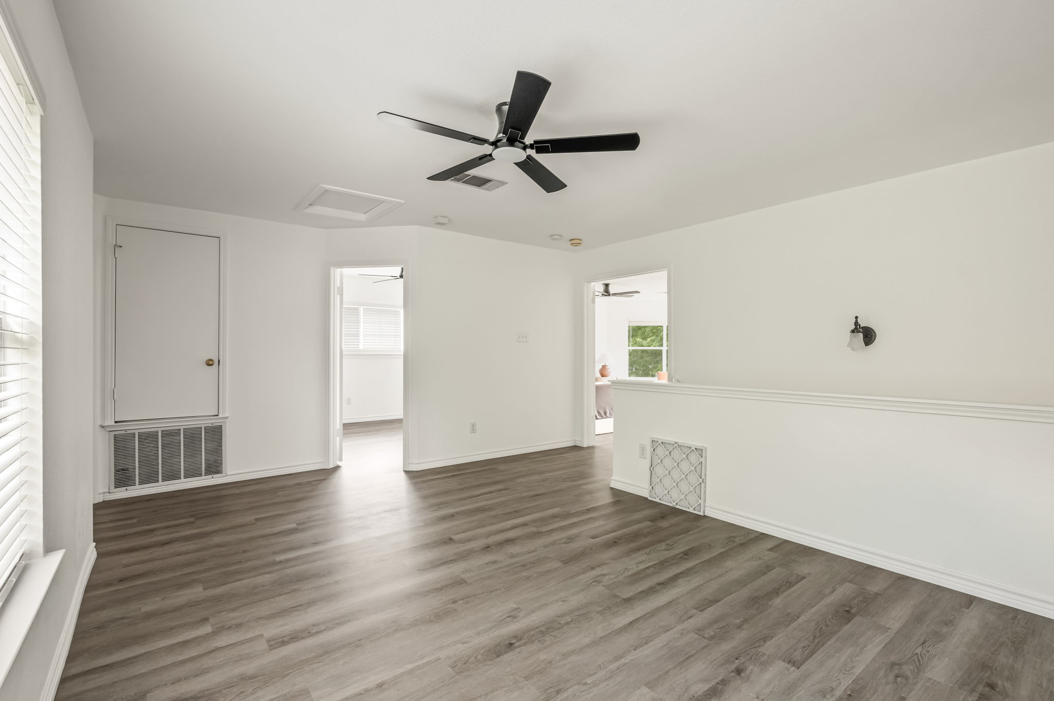 1408 Water Spaniel Way Round Rock, TX 78664 - Photo 19 of 37 A versatile open-concept space featuring durable plank flooring and a modern ceiling fan.