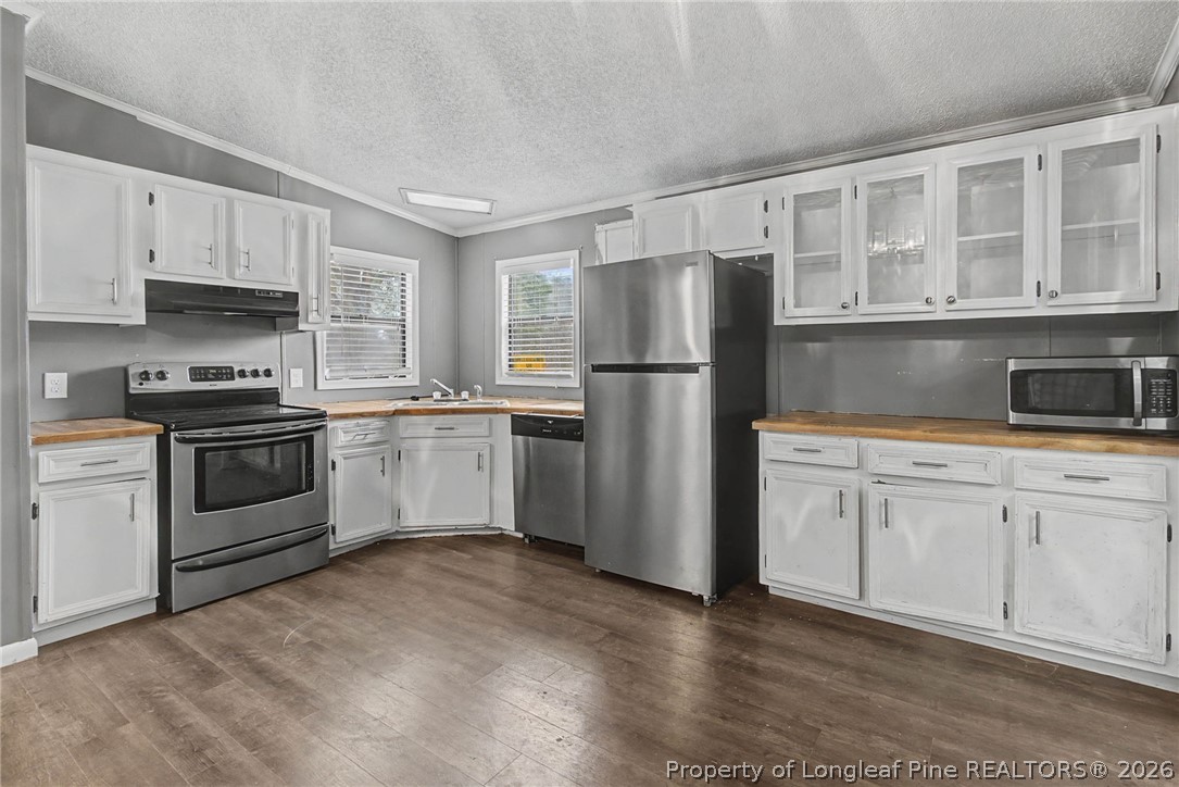 1512 Seabrook School Road Fayetteville, NC 28312 - Photo 21 of 30 a kitchen with cabinets stainless steel appliances and window