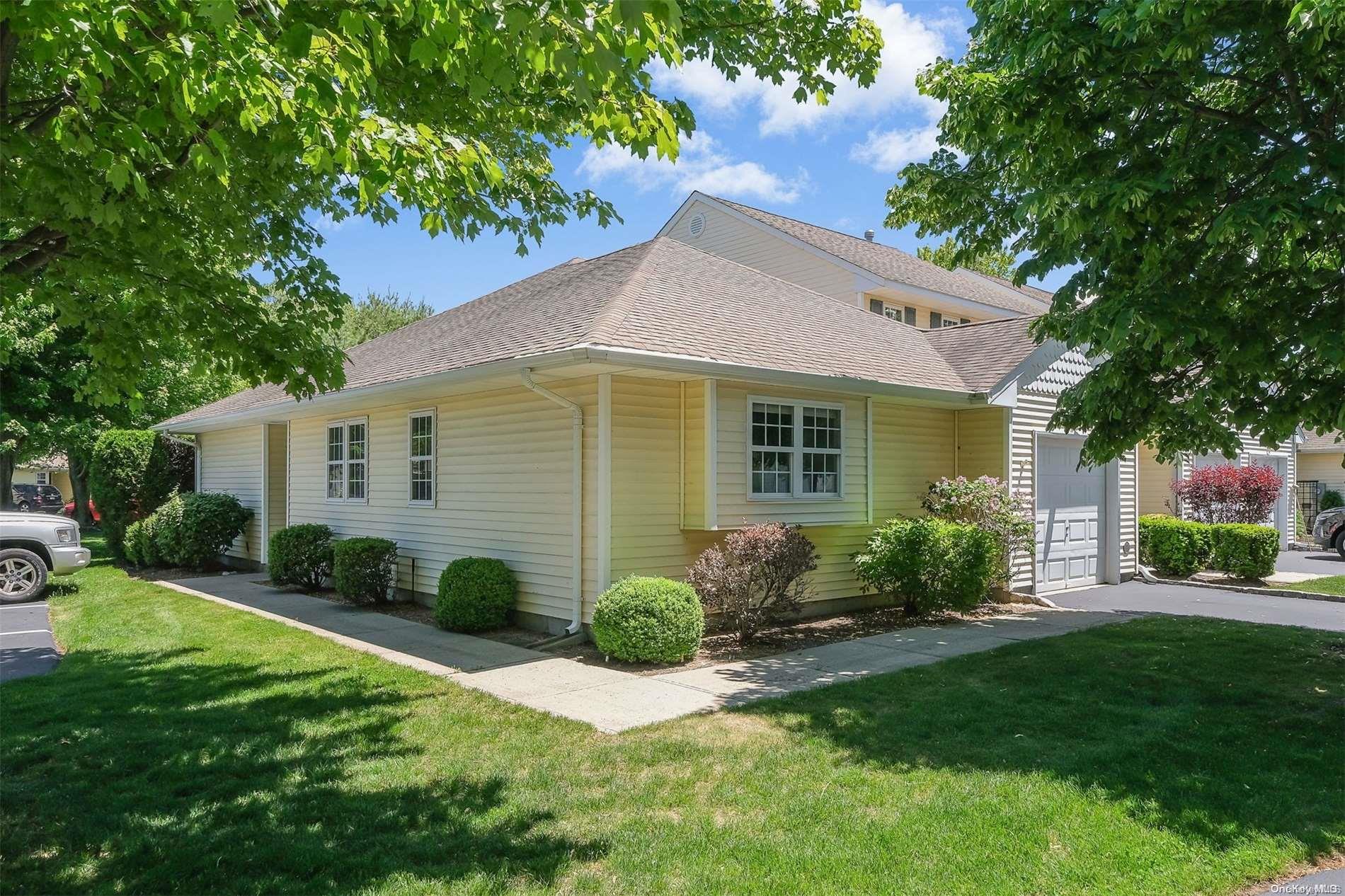 a view of a house with a yard and potted plants