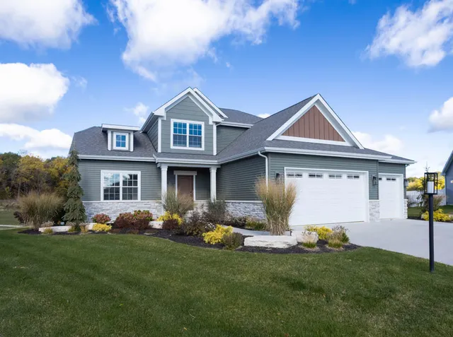 a front view of house with yard and green space