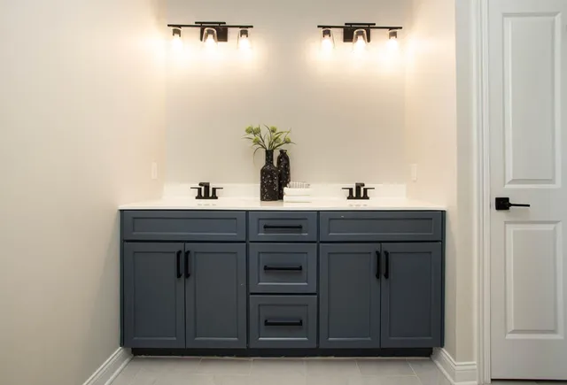 a bathroom with a sink vanity and mirror