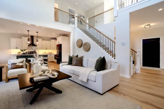 a living room with furniture and a wooden floor